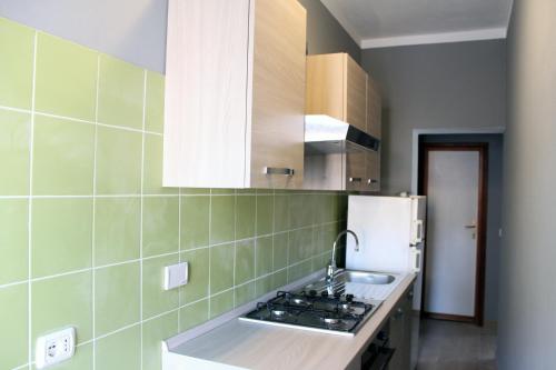 a kitchen with a stove and a refrigerator at Struttura Turistica Villa Calamita in Capoliveri
