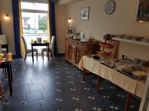 a kitchen with two tables and a table with food on it at Hotel Appart in Osnabrück