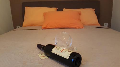 a bottle of wine sitting on top of a bed at Apartment Djordje Budva-Jaz in Kukaljevina