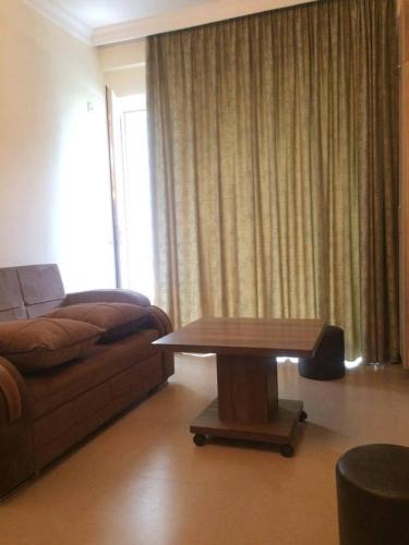 a living room with a couch and a coffee table at Kvariati G in Kvariati