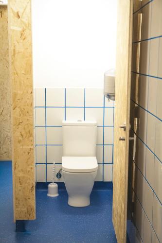 a bathroom with a toilet in a blue tiled room at Estela do Mar in Baiona