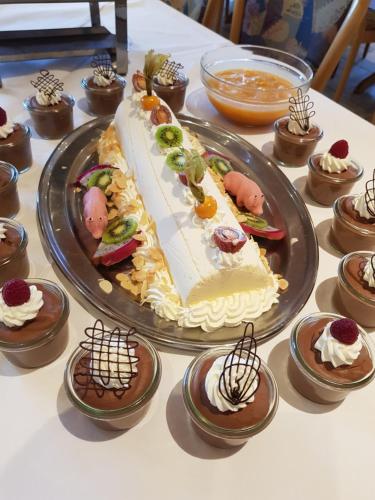 a table with a large cake and cupcakes at Hotel zur Waage in Bad Münstereifel