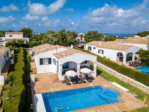 an aerial view of a villa with a swimming pool at Villas Finesse By MENORCARENTALS in Son Bou