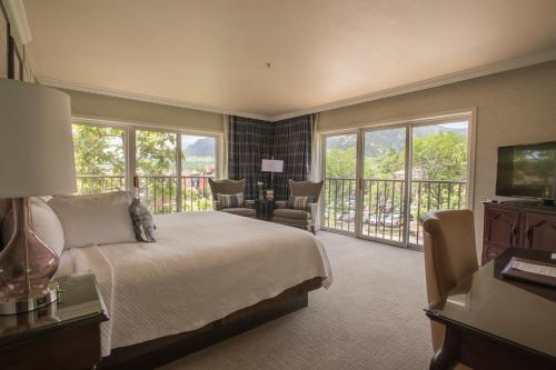 a bedroom with a bed and a balcony at Hotel Boulderado in Boulder