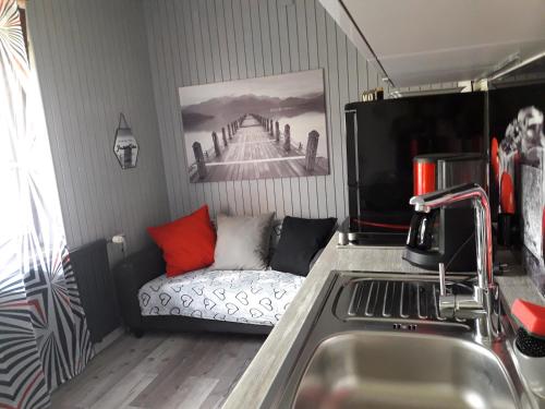 a kitchen with a couch in the corner of a room at Snežak (Snowman) in Bohinj