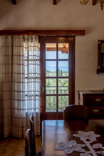 a living room with a table and a large window at Villa Artjeta in Kastrosikia