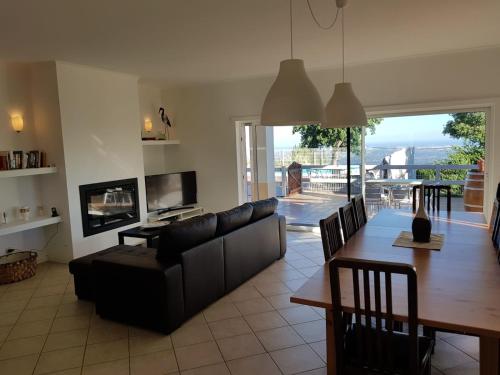a living room with a couch and a table and a dining room at Luar do Cano in Monchique