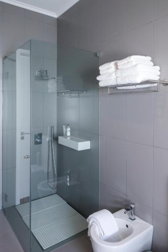 a bathroom with a shower and a toilet and a sink at Quinta do Jasmim in Ponta Delgada