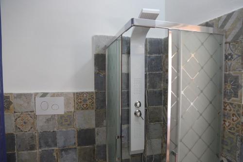 a shower with a glass door in a bathroom at B&B Il Melograno Antico con Terrazza e Giardino in Agrigento