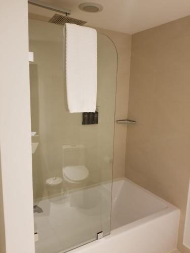 a bathroom with a glass shower with a toilet at Rent in LYFE Resort in Hollywood