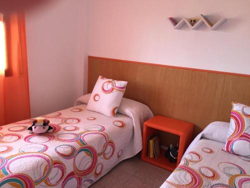 a bedroom with two beds and a stuffed animal on the bed at Bonito y Acogedor Apartamento con fibra in Salou