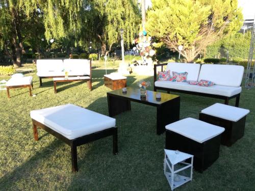 a group of benches and tables on the grass at Establecimiento Rural El Chañar in San Rafael
