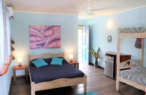 a bedroom with a bed and a bunk bed at Cafe de la Suerte in Pavones