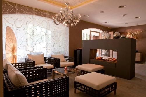 a living room with chairs and a fire place at Hotel Seespitz Superior - Adults Only in Seefeld in Tirol