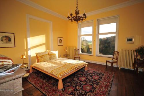 a bedroom with a bed and a large window at Chateau De Hodbomont in Theux