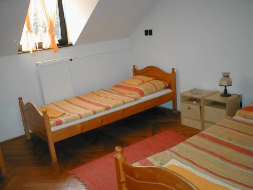 A bed or beds in a room at Krisztina Panzió