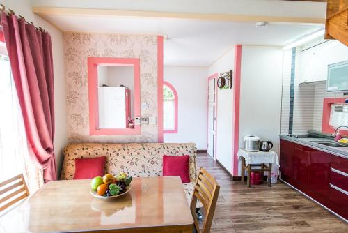 a kitchen and living room with a table and a couch at Sunny House in Pyeongchang 