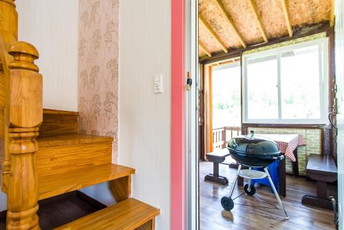 a room with a table and a grill in a room at Sunny House in Pyeongchang 