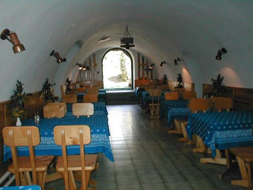 a restaurant with blue tables and chairs in a room at Krisztina Panzió in Balatonalmádi