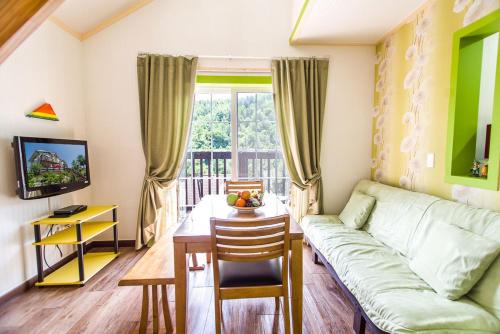 a living room with a couch and a table at Sunny House in Pyeongchang 