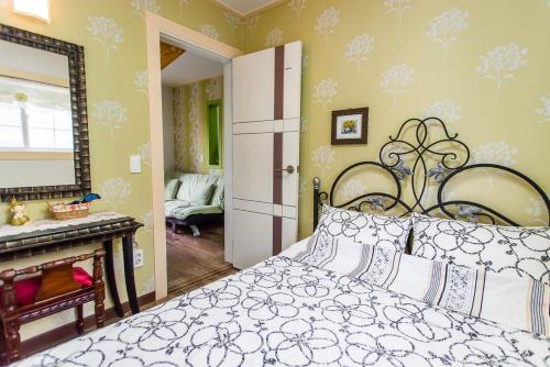 a bedroom with a bed and a mirror at Sunny House in Pyeongchang 