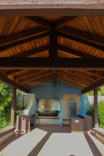 a living room with a fireplace and a wooden ceiling at Villas La Quinta in Creel
