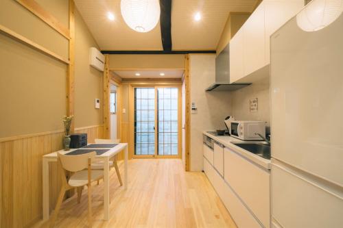 a kitchen with a table and chairs in a room at Miro Saiinnishi Imadacho Tei in Kyoto