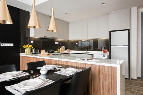 a kitchen with a table and chairs and a counter at Somerset Damansara Uptown Petaling Jaya in Petaling Jaya