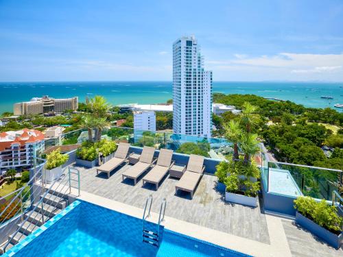 an image of the pool at the resort with the ocean in the background at The Point by Tech in Pattaya South