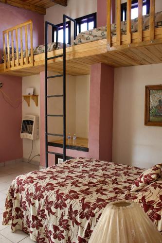 a bedroom with two bunk beds and a bed at Villas La Quinta in Creel