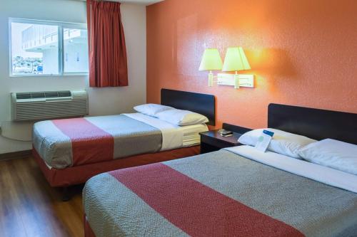 a hotel room with two beds and a window at Motel 6-Bakersfield, CA - East in Bakersfield