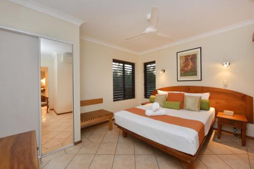 a bedroom with a large bed in a room at Seascape Holidays - Hibiscus in Port Douglas