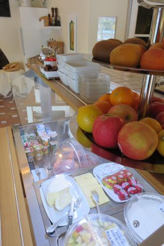 a buffet with apples and other food on a table at L'Enclos des Lauriers Roses in Cabrières