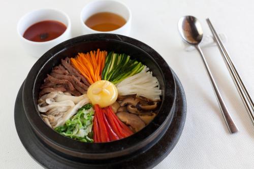 a bowl of food with vegetables in it on a table at Safari Park Hotel in Nairobi