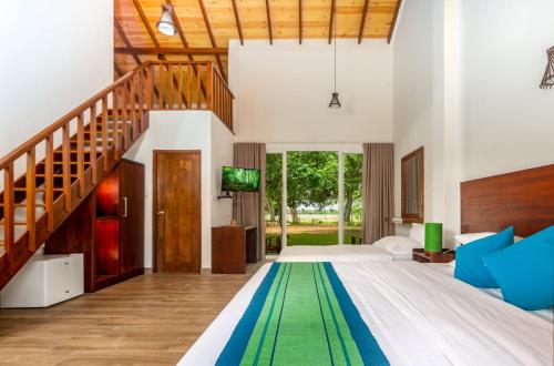 a bedroom with a large bed and a staircase at Tranquil Wild in Tanamalwila