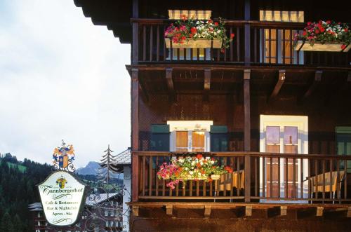 a building with flower boxes on the balconies of it at Hotel Tannbergerhof im Zentrum von Lech in Lech am Arlberg