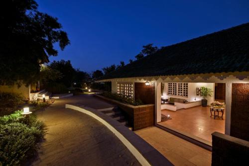 a house with a patio at night at The Fern Samali Resort in Dapoli