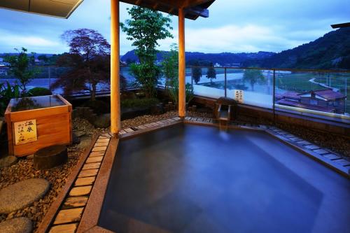 a swimming pool in a house with a view at Hot spring inn Snow country(yukiguni) in Tsunan