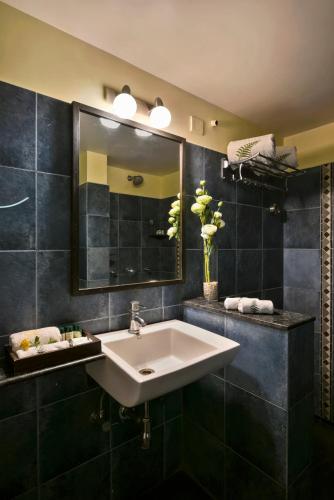 a bathroom with a sink and a mirror at The Fern Samali Resort in Dapoli