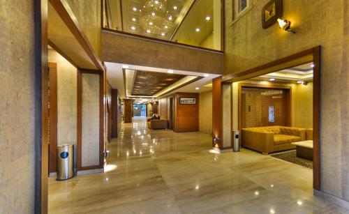 a hallway of a hotel lobby with a couch at Clarks inn srinagar in Srinagar