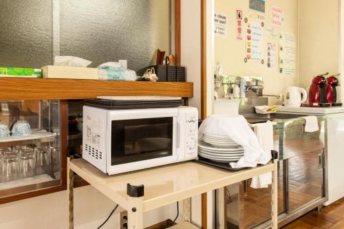 a microwave sitting on a table in a kitchen at Yamanaka Lake Ryozan in Yamanakako