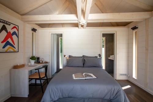 a bedroom with a bed with a book on it at Domaine Monte Verdi in Flayosc