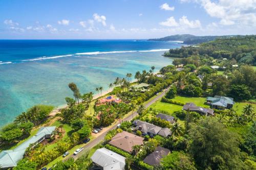 an aerial view of a beach with houses and the ocean at Anini Ohana Hale TVNC#4255 in Kilauea