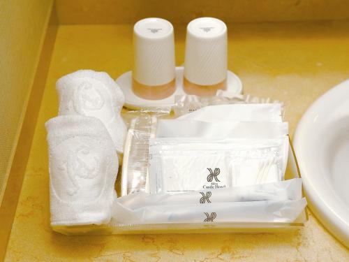 a tray with toilet paper and towels on a table at Akita Castle Hotel in Akita