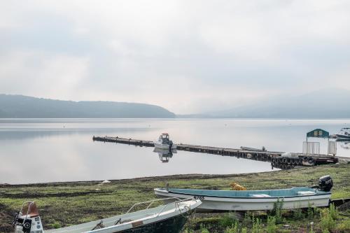 two boats are parked at a dock on a lake at Yamanaka Lake Ryozan in Yamanakako