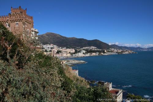 a castle on a hill next to a body of water at Stanza d'artista in Genova