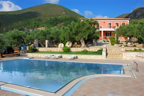 a large swimming pool in front of a house at Anatoli Labreon in Agia Marina