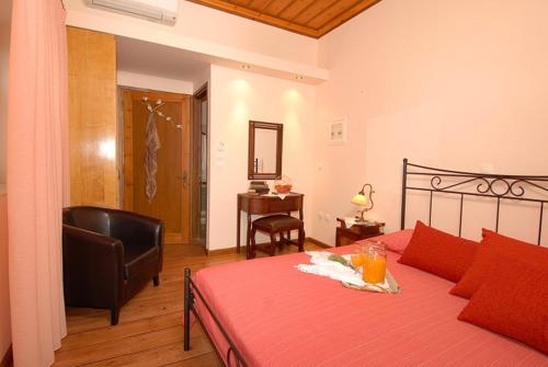 a bedroom with a bed and a chair and a desk at Anatoli Labreon in Agia Marina