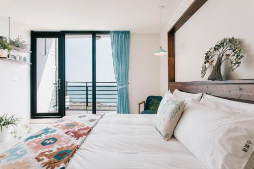 Chuanfanrock Haku Beach Days Innにあるベッド