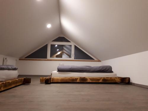 a attic bedroom with a bed and a window at Apartmaji Daniel in Kranjska Gora
